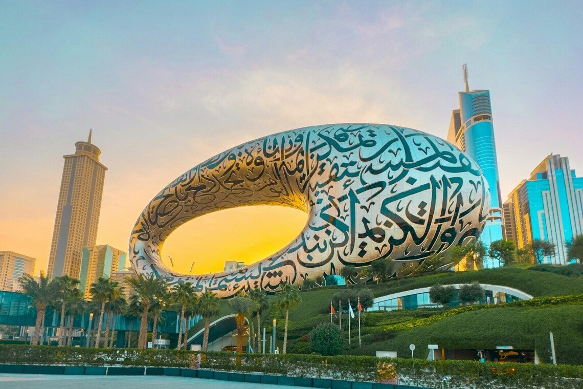 a large sculpture of a whale in front of a cityscape