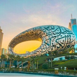 a large sculpture of a whale in front of a cityscape